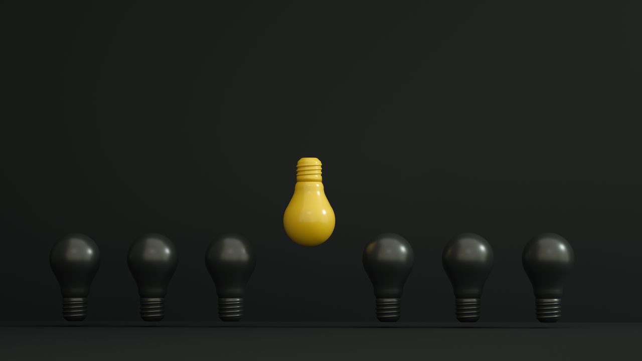 pexels photo 12198521 A single yellow light bulb highlighted among dark ones symbolizing creativity and innovation.